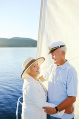 Fototapeta na wymiar Affectionate senior couple embracing during summer voyage
