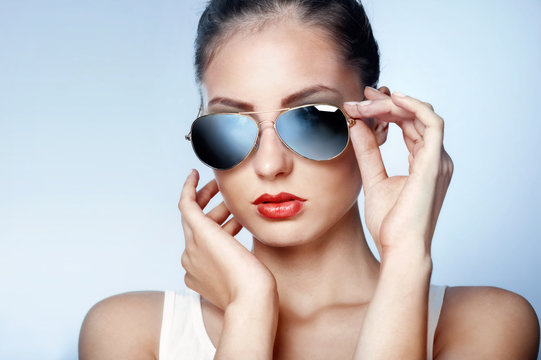 Stylish young woman in blue mirrored sunglasses