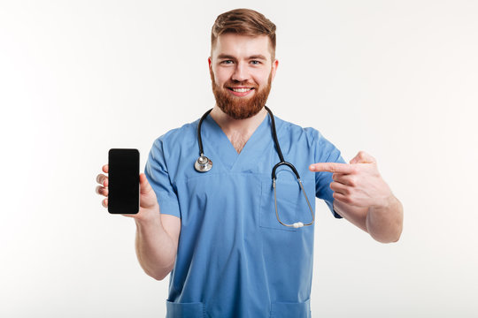 Doctor showing phone and smiling.