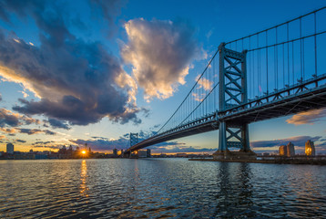 The Benjamin Franklin Bridge and and Delaware River at sunset, seen from Camden, New Jersey.