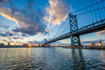The Benjamin Franklin Bridge and and Delaware River at sunset, seen from Camden, New Jersey.