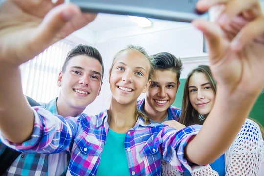  teenagers making fun selfie