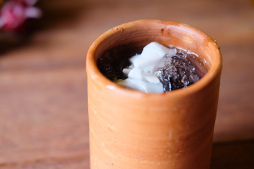 Butterfly pea water and topped with coconut meat