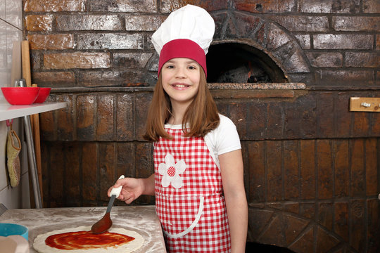 happy little girl cook real pizza