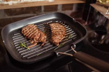 Grilled steaks in frying pan