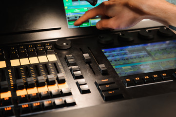 A lighting engineer works with lights technicians control on the concert show. Professional light...