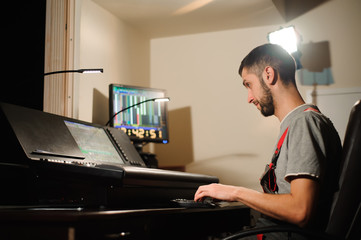 A lighting engineer works with lights technicians control on the concert show. Professional light...