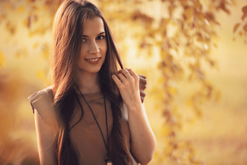 Fototapeta premium Summer sunny park portrait of a beautiful young woman