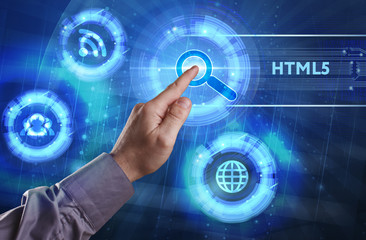 Business, Technology, Internet and network concept. Young businessman working on a virtual screen of the future and sees the inscription: HTML5