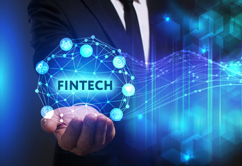 Business, Technology, Internet and network concept. Young businessman working on a virtual screen of the future and sees the inscription: Fintech