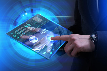 Business, Technology, Internet and network concept. Young businessman working on a virtual screen of the future and sees the inscription: IOT