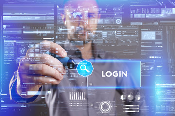 Fototapeta premium Business, Technology, Internet and network concept. Young businessman working on a virtual screen of the future and sees the inscription: Login