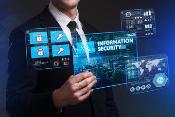Business, Technology, Internet and network concept. Young businessman working on a virtual screen of the future and sees the inscription: Information security