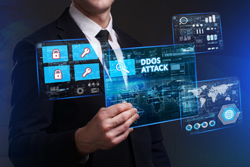Business, Technology, Internet and network concept. Young businessman working on a virtual screen of the future and sees the inscription: Ddos attack