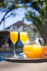 Close up image of a jug of juice and two champagne glasses at an upmarket guesthouse