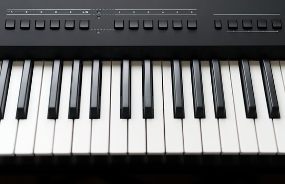 Professional midi keyboard synthesizer with knobs and controllers.