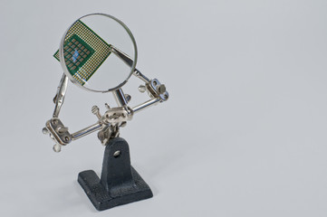 The CPU is magnified by a magnifying glass