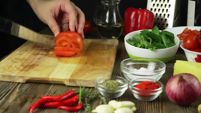 Knife Cuts Tomato On Wooden Board