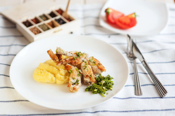 Fried frog legs with herbs and potatos