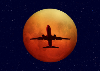 Passenger airplane with lunar eclipse"Elements of this image furnished by NASA "