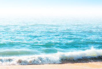 Naklejka na ściany i meble Seafoam on the coast with water surface on the background