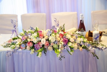 Main table at a wedding reception with beautiful flowers