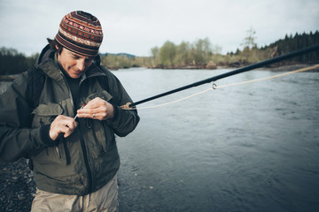 Middle aged man fly fishing on the Hoh River, Olympic National Park, Washington.