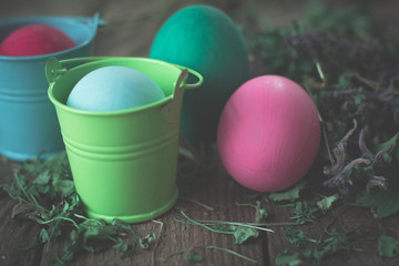 Easter eggs in colored buckets.