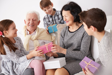 Grandparents and grandchildren exchanging gifts