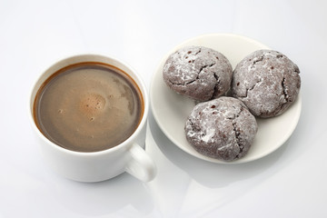 cup of black coffee with biscuits on white background