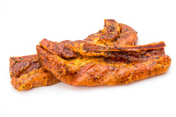 Spicy marinated spare ribs barbecued on the white background.