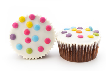 Multiple colorful decorated muffins on a white background.
