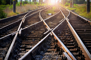 Railroad tracks leading into the sunset