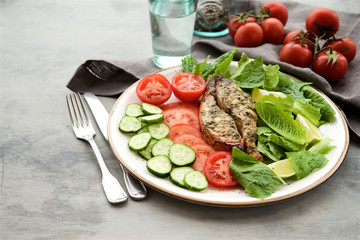Baked salmon in a lemon-honey dressing with herbs served with fresh vegetables and salad 
