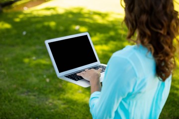 Woman using laptop in park