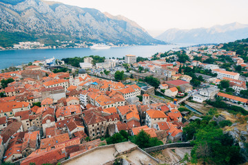 Naklejka na ściany i meble Liner on the dock in Kotor, near the Old Town in Bay of Kotor, Montenegro. The view from the observation deck over the city.
