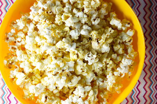 Cheesy popcorn in a yellow bowl
