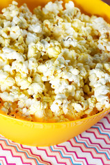 Cheesy popcorn in a yellow bowl