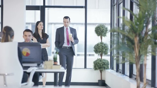  Business man & woman having conversation in modern city office