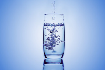 Water pouring into the glasses