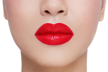 Fototapeta premium Close-up shot of beautiful woman lips over white background