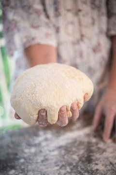 Bread dough hold by hand