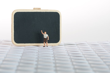 Strict mistress in front of a blackboard - miniature model