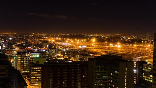 A night timelapse of the city centre of Johannesburg (CBD) at nightfall in peak traffic showing the Sentech Tower in the Braamfontein, New Town area, South Africa