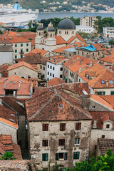 Fototapeta na wymiar The Old Town of Kotor. The orange-tiled rooftops of the city. Shooting from the observation platform on the wall of the city. Montenegro