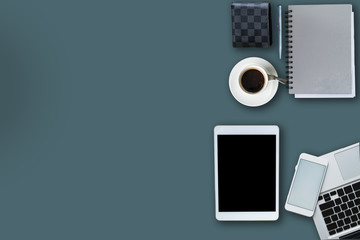 office equipment,laptop computer, smartphone with white screen over a notebook and cup of coffee. Top view with copy space, flat lay.