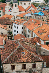Fototapeta na wymiar The Old Town of Kotor. The orange-tiled rooftops of the city. Shooting from the observation platform on the wall of the city. Montenegro