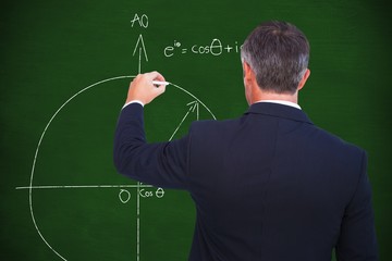 Composite image of rear view of businessman writing with chalk