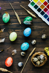 Top view of easter table with colored eggs on it.