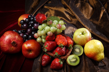 Juicy bright fruit, sprinkled with water, still life of seasonal fruits and berries, top view